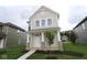 Two-story home featuring a welcoming front porch with stone accents and a well-maintained lawn at 1821 Real St, Indianapolis, IN 46240