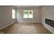 Bright living area featuring large windows, neutral walls, and a modern fireplace, ideal for relaxation at 1821 Real St, Indianapolis, IN 46240