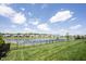 Scenic backyard with a pond view, lush green lawn, and a black fence at 1872 Wellpark Dr, Westfield, IN 46074