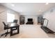 Versatile basement space with a home office area, entertainment setup, and fitness equipment at 1872 Wellpark Dr, Westfield, IN 46074