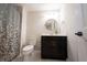 Bathroom featuring a toilet, vanity with storage, framed mirror, and patterned shower curtain at 1872 Wellpark Dr, Westfield, IN 46074