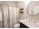 Cozy bathroom with a shower/tub, decorative curtain, a round mirror and floating shelves at 1872 Wellpark Dr, Westfield, IN 46074