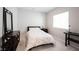 Cozy bedroom with a floral patterned comforter, bedside table, and a light-filled window at 1872 Wellpark Dr, Westfield, IN 46074