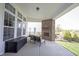 Covered patio with brick fireplace, comfortable seating, and a view of the backyard at 1872 Wellpark Dr, Westfield, IN 46074