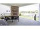 Covered patio with a brick fireplace overlooking the pond and backyard at 1872 Wellpark Dr, Westfield, IN 46074