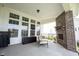 Covered patio with brick fireplace, patio furniture, and backyard views at 1872 Wellpark Dr, Westfield, IN 46074