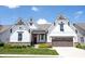 Charming two-story home featuring stone accents, white siding, a red door, and a two-car garage at 1872 Wellpark Dr, Westfield, IN 46074