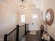 Warm foyer featuring wood floors, staircase, and a view of the front door and decorative mirror at 1872 Wellpark Dr, Westfield, IN 46074