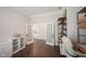 Home office with dark wood floors, white trim, and French doors leading into hallway at 1872 Wellpark Dr, Westfield, IN 46074