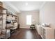 Bright home office with modern decor, featuring wood floors, white trim, and decorative bookshelves at 1872 Wellpark Dr, Westfield, IN 46074