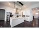 Open concept kitchen with center island, stainless steel appliances, white cabinets, and hardwood floors at 1872 Wellpark Dr, Westfield, IN 46074