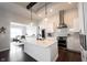 Open concept kitchen with white cabinets, stainless steel appliances and view into dining area at 1872 Wellpark Dr, Westfield, IN 46074