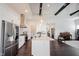 Open concept kitchen with stainless steel appliances that opens to the living room with piano at 1872 Wellpark Dr, Westfield, IN 46074