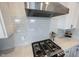 Close up on a kitchen range with stainless steel hood and white cabinets with subway tile backsplash at 1872 Wellpark Dr, Westfield, IN 46074