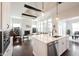 Spacious kitchen open to the living room with stainless steel appliances, white cabinets and quartz countertops at 1872 Wellpark Dr, Westfield, IN 46074
