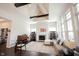 Living room featuring vaulted ceiling, large windows, fireplace, and comfortable couch with view to entry way at 1872 Wellpark Dr, Westfield, IN 46074