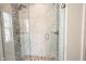 Close-up of a glass shower with decorative pebble accents and dual shower heads at 1872 Wellpark Dr, Westfield, IN 46074