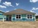 Spacious backyard view of a home under construction, showing large windows and a door at 188 Springfield Xing, Greenfield, IN 46140