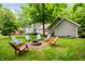 Large backyard features a fire pit with chairs perfect for gathering outdoors with friends and Gathering at 2508 W Sun Valley Pkwy, Muncie, IN 47303