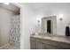 Bathroom with granite countertops, patterned shower curtain and gray cabinets at 2508 W Sun Valley Pkwy, Muncie, IN 47303