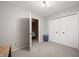 Carpeted bedroom with closet, an open door and neutral paint at 2508 W Sun Valley Pkwy, Muncie, IN 47303