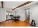 Dining area with hardwood floors, wood beam ceiling, and view to the living room at 2508 W Sun Valley Pkwy, Muncie, IN 47303