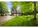Charming exterior of home with a two-car garage, long drive way, and a lush green front yard at 2508 W Sun Valley Pkwy, Muncie, IN 47303