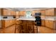 Bright kitchen featuring wooden cabinetry, stainless steel appliances, and a central island with seating at 2508 W Sun Valley Pkwy, Muncie, IN 47303