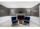 Cozy living room with fireplace, wall sconces, and two chairs for conversations and relaxation at 2508 W Sun Valley Pkwy, Muncie, IN 47303
