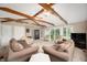 Large sun room with exposed beams, ceiling fan and multiple seating arrangements at 2508 W Sun Valley Pkwy, Muncie, IN 47303