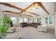 Large sun room with exposed beams, ceiling fan and multiple seating arrangements at 2508 W Sun Valley Pkwy, Muncie, IN 47303