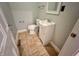 Compact half bathroom with tiled floor, standard toilet and sink at 2918 Ruckle St, Indianapolis, IN 46205