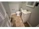 This bathroom has a toilet, a sink and vanity, tan tile floors, and gray walls at 2918 Ruckle St, Indianapolis, IN 46205