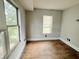 Bright bedroom featuring hardwood floors and natural light from a large window at 2918 Ruckle St, Indianapolis, IN 46205