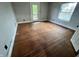 Bedroom with hardwood floors, natural light, and white trim around the window at 2918 Ruckle St, Indianapolis, IN 46205