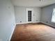 Spacious bedroom featuring light gray walls and original hardwood flooring at 2918 Ruckle St, Indianapolis, IN 46205