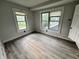 This bedroom has gray laminate floors and two large windows that let in lots of natural light at 2918 Ruckle St, Indianapolis, IN 46205