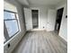 Well-lit bedroom with new grey vinyl flooring and access to closet at 2918 Ruckle St, Indianapolis, IN 46205