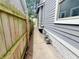 A narrow walkway between a wooden fence and the house at 2918 Ruckle St, Indianapolis, IN 46205