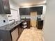 A functional kitchen featuring sleek cabinetry, granite countertops, and a stainless steel dishwasher at 2918 Ruckle St, Indianapolis, IN 46205