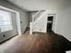 A view of the living room featuring stairs and original hardwood floors at 2918 Ruckle St, Indianapolis, IN 46205