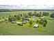 Overhead view of a quaint home on a well-manicured lot surrounded by fields at 303 E County Road 500 N, Pittsboro, IN 46167