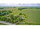 Aerial view of home and surrounding farmland featuring mature trees and outbuildings at 303 E County Road 500 N, Pittsboro, IN 46167