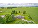 Aerial view of home featuring surrounding farmland, mature trees and outbuildings at 303 E County Road 500 N, Pittsboro, IN 46167