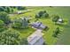 Manicured lawn, mature trees, and multiple outbuildings provide country charm at 303 E County Road 500 N, Pittsboro, IN 46167