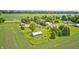 Breathtaking aerial view of a charming home with expansive green fields at 303 E County Road 500 N, Pittsboro, IN 46167