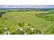 Aerial perspective shows rural house, fields, and surrounding greenery at 303 E County Road 500 N, Pittsboro, IN 46167