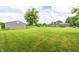 Expansive backyard featuring a well-maintained lawn and a large storage shed at 303 E County Road 500 N, Pittsboro, IN 46167
