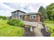 Charming backyard with a deck, landscaping, and a well-maintained lawn, perfect for outdoor enjoyment at 303 E County Road 500 N, Pittsboro, IN 46167