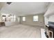 Open basement area featuring a fireplace, stairs to the kitchen, and multiple windows at 303 E County Road 500 N, Pittsboro, IN 46167
